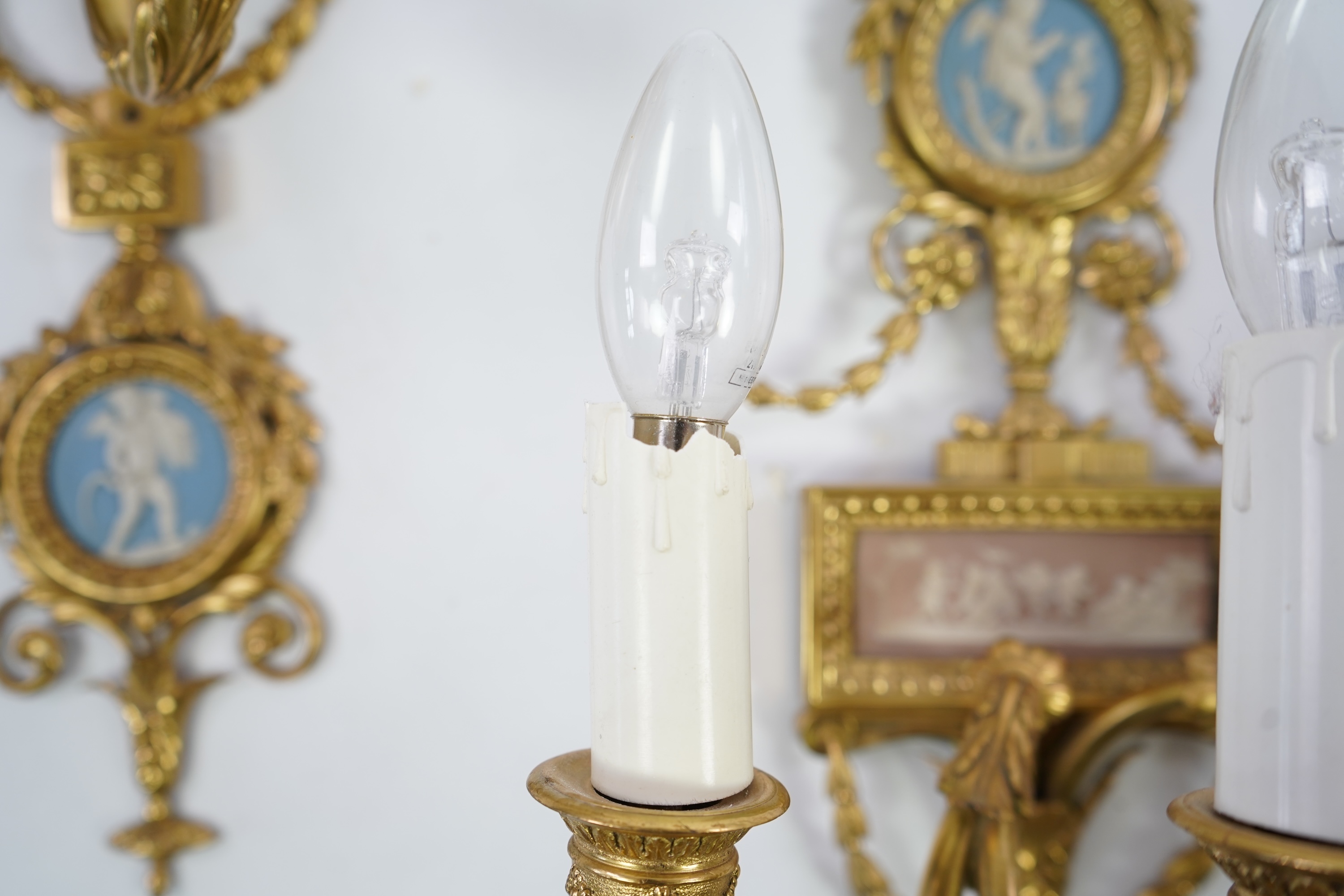 A set of four Adam style ormolu and jasper ware mounted wall appliques, early 20th century